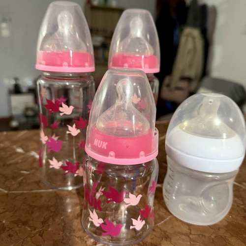 4 baby feeding bottles, 3 glass NUK, 1 plastic Philips