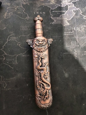 Metal sword lighter with embossed dragon used