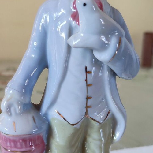 Vintage porcelain figurine Victorian man with bird and cage