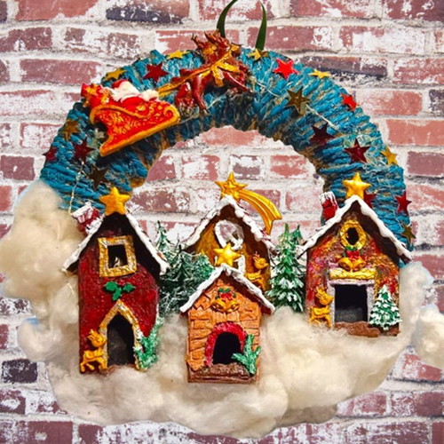 Handmade wreath Santa Claus with sleigh in Christmas village lit with LED