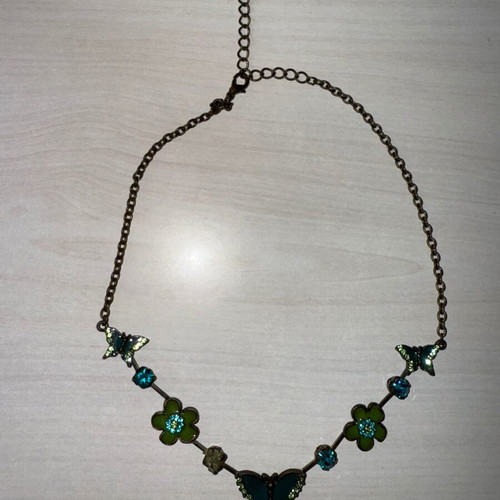 Green necklace used with small butterflies and flowers