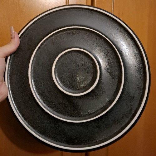 Porcelain plate used, black with small chip