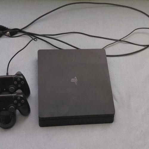 PlayStation 4 Slim 500GB used with 2 controllers and 33 games