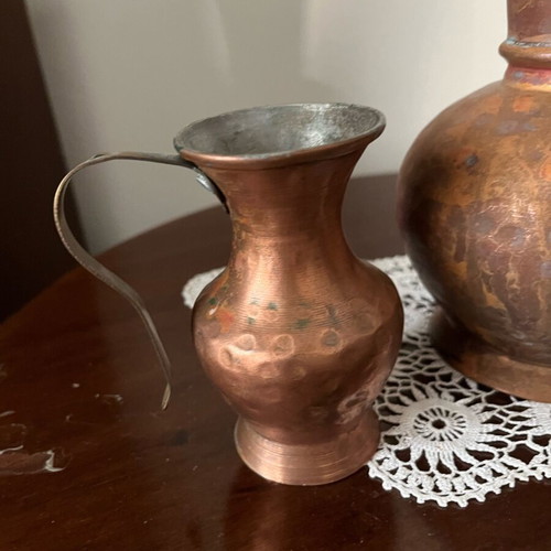 Two decorative hammered copper vases used with natural patina