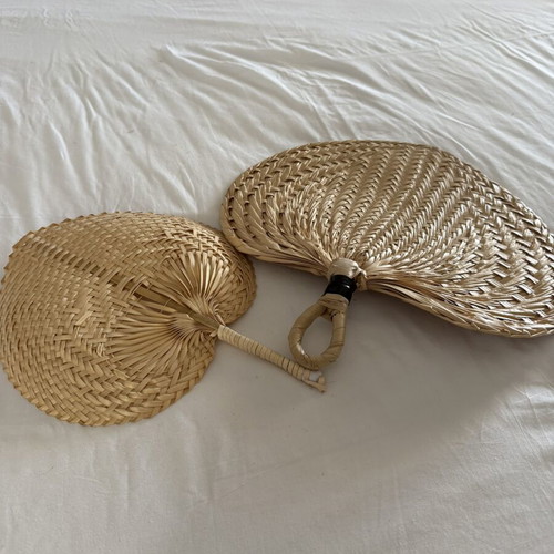 Handmade fans used, natural materials palm leaves and rattan