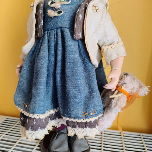 Porcelain doll with stand, 42 cm
