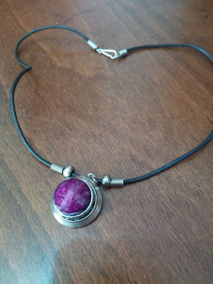 Pendant with purple glass cabochon on leather strap used