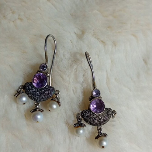 Silver earrings used with purple stones and pearls