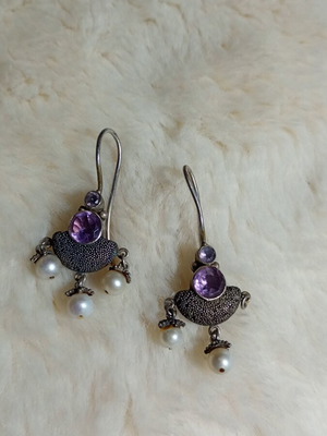 Silver earrings used with purple stones and pearls