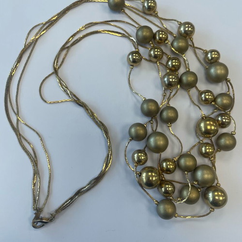 Statement necklace used with shiny and matte gold beads