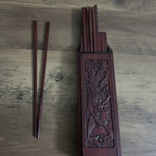 Japanese wooden box with 16 used chopsticks and palm carving