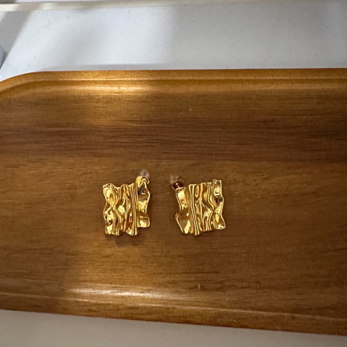 Earrings new in gold color with embossed design