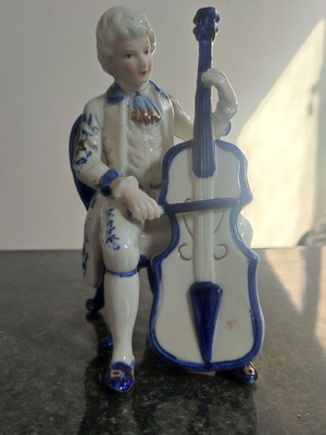 Vintage porcelain musician with cello used decorative antique art