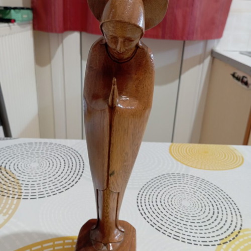 Handmade wooden Madonna statue in praying pose with halo