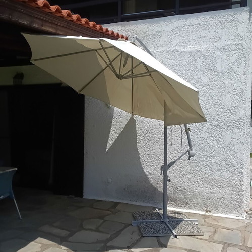 Garden umbrella used, white fabric with support plates