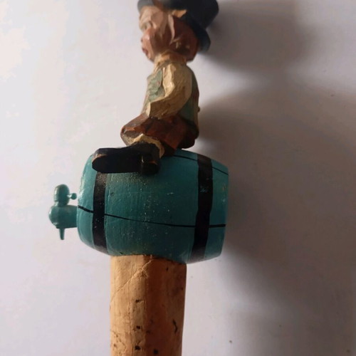 Cork used with carved wooden bottle stopper and boy figure
