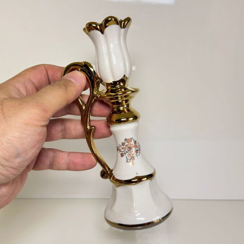 Ceramic candlestick with gold details and floral cross design