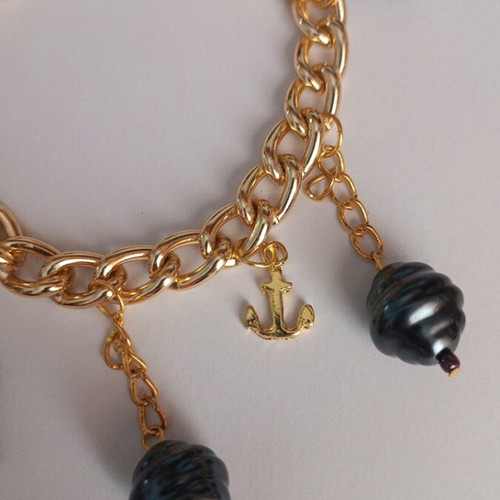Gold bracelet with charms, new, dark blue details