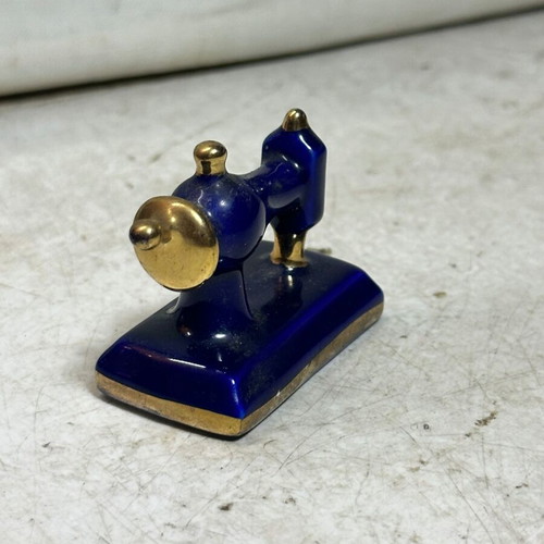 Vintage porcelain miniature sewing machine with gold details, used