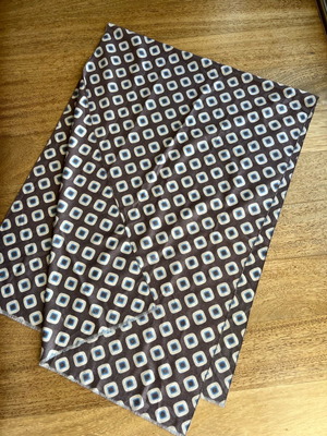 Scarf used with patterns in brown, blue, ecru