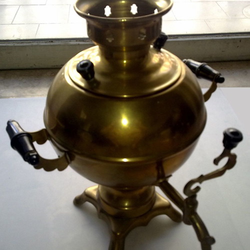 Bronze teapot with spout and heating element used