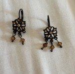 Dangling earrings used, missing one pendant