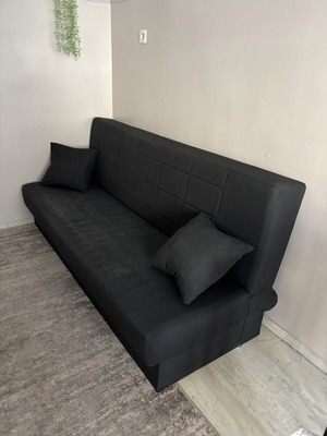 Sofa bed with storage used, black, three-seater