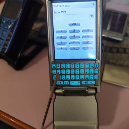 Sony Ericsson P990i vintage cell phone used with charger