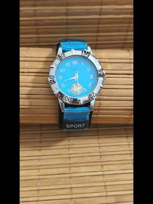 Analog sport watch used with blue dial and strap