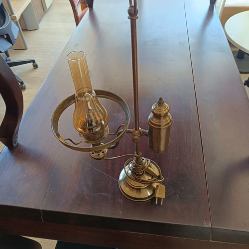 Retro table lamp made of brass used, oil lamp style with amber glass chimney