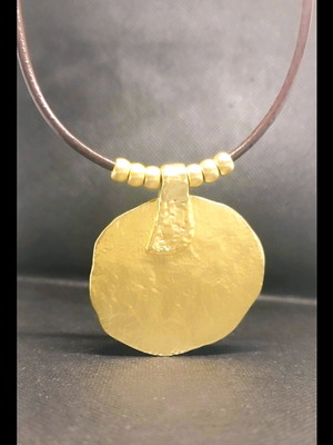 Necklace like new with brown leather cord and gold tone