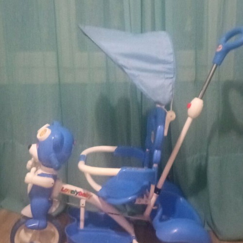 Baby blue tricycle used with canopy, storage, and adjustable parent handle