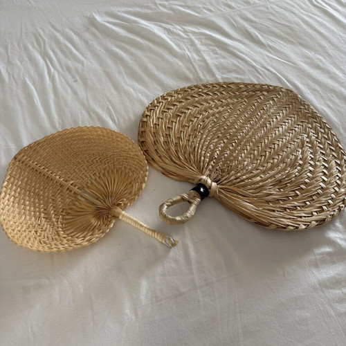 Handmade fans used, natural materials palm leaves and rattan