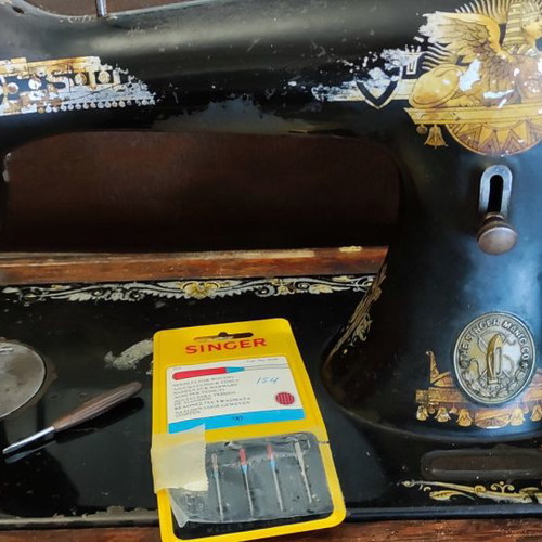 Singer sewing machine used with original wooden cover and key