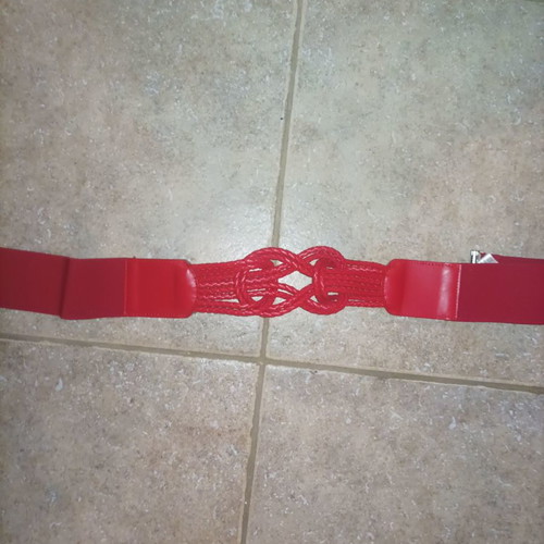 Red women's belt with intricate detail