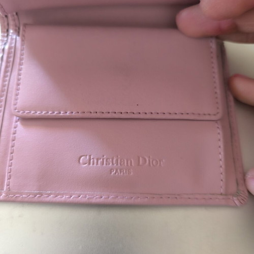 Dior wallet used, pink with slight wear and missing stud