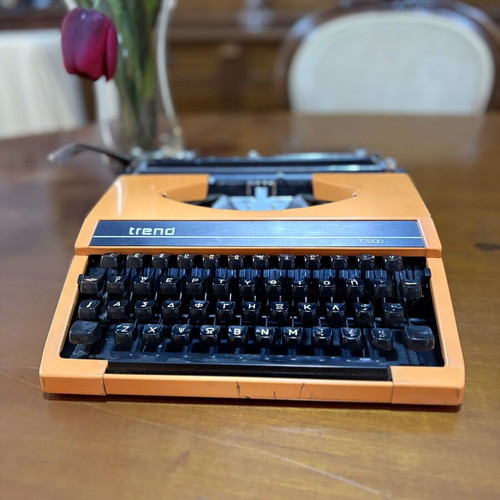 Vintage Trend Typewriter used with ribbon and case, orange color