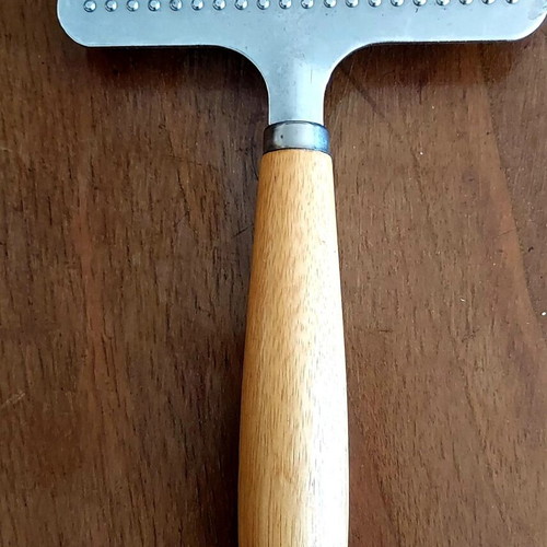 Grooming rake like new with metal teeth and wooden handle