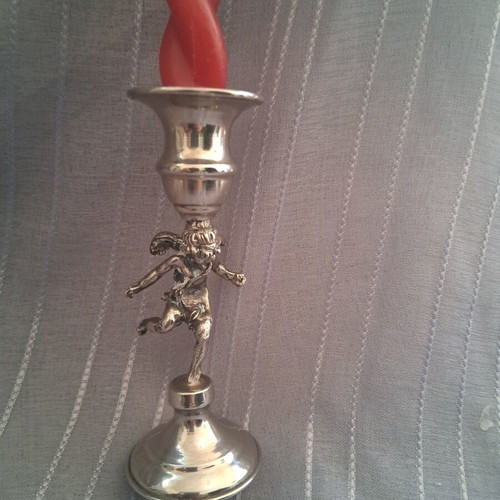 Vintage candlestick with cherub figure