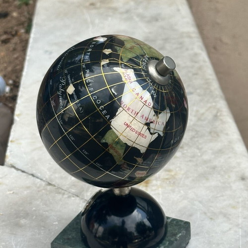 Decorative globe made of semi-precious stones with clock and marble base used