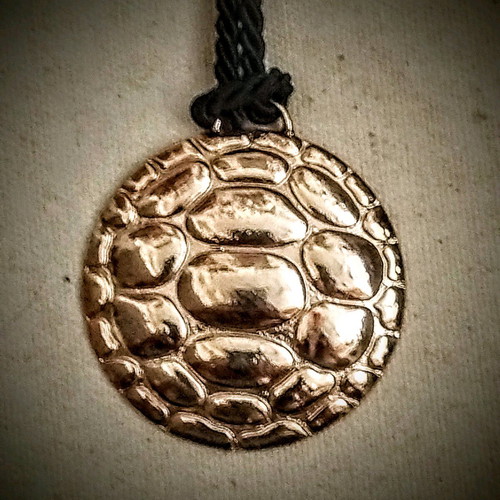 Pendant like new with turtle design on black cord
