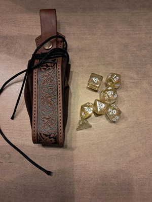 Brown leather dice bag with golden flaked D&D dice set