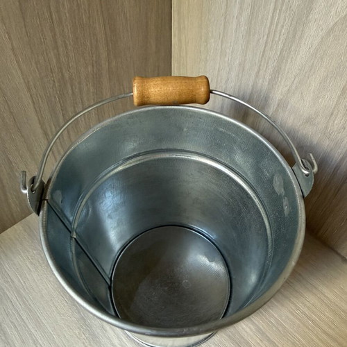 Decorative galvanized metal bucket with wooden handle