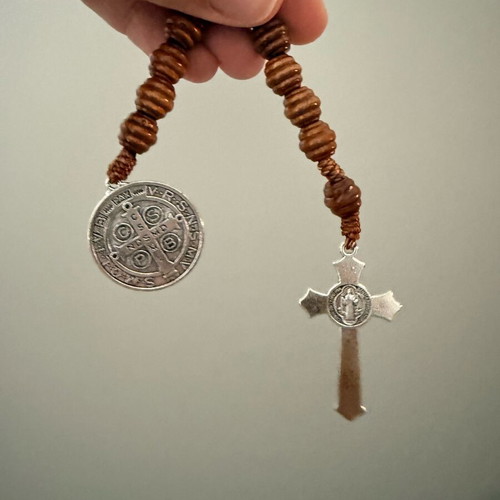 Religious bracelet with wooden beads, cross pendant, and Saint Benedict medal
