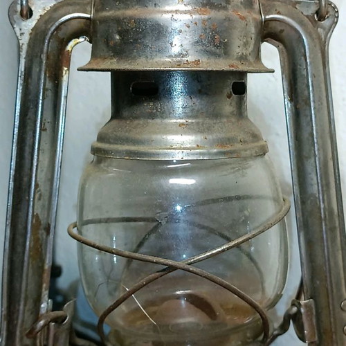 Vintage storm lantern used with cracked glass