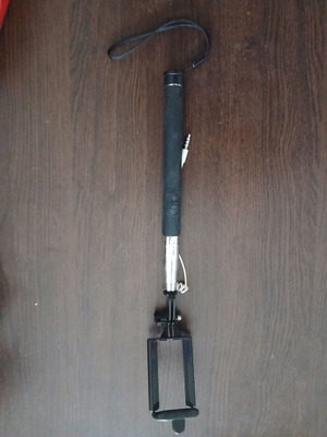 Selfie stick used with white cable for mobile phones