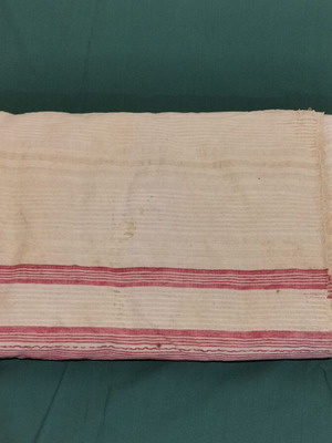 Woven bed sheet used with stain and wear, circa 1920