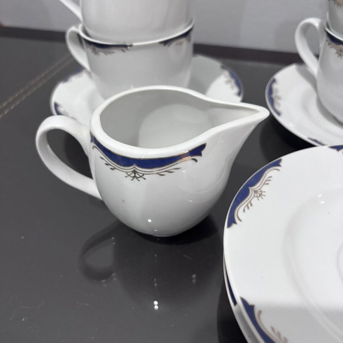 Tea set with 4 cups, saucers and creamer like new