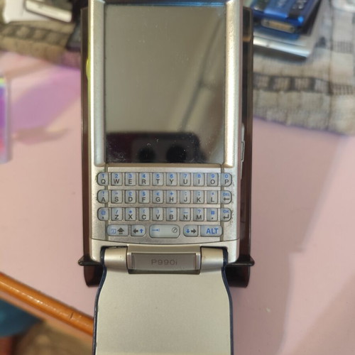 Sony Ericsson P990i vintage cell phone used with charger