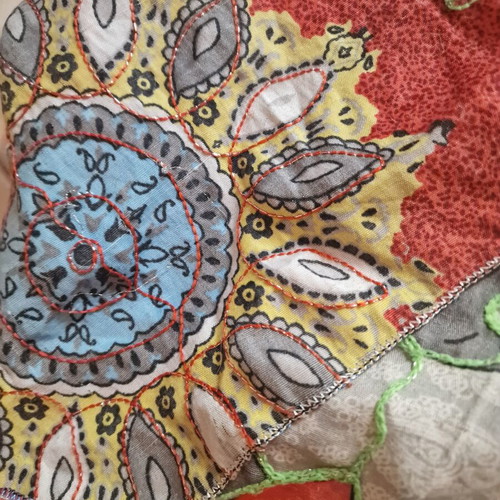 Throw from India used with hand-stitched colorful animal motifs